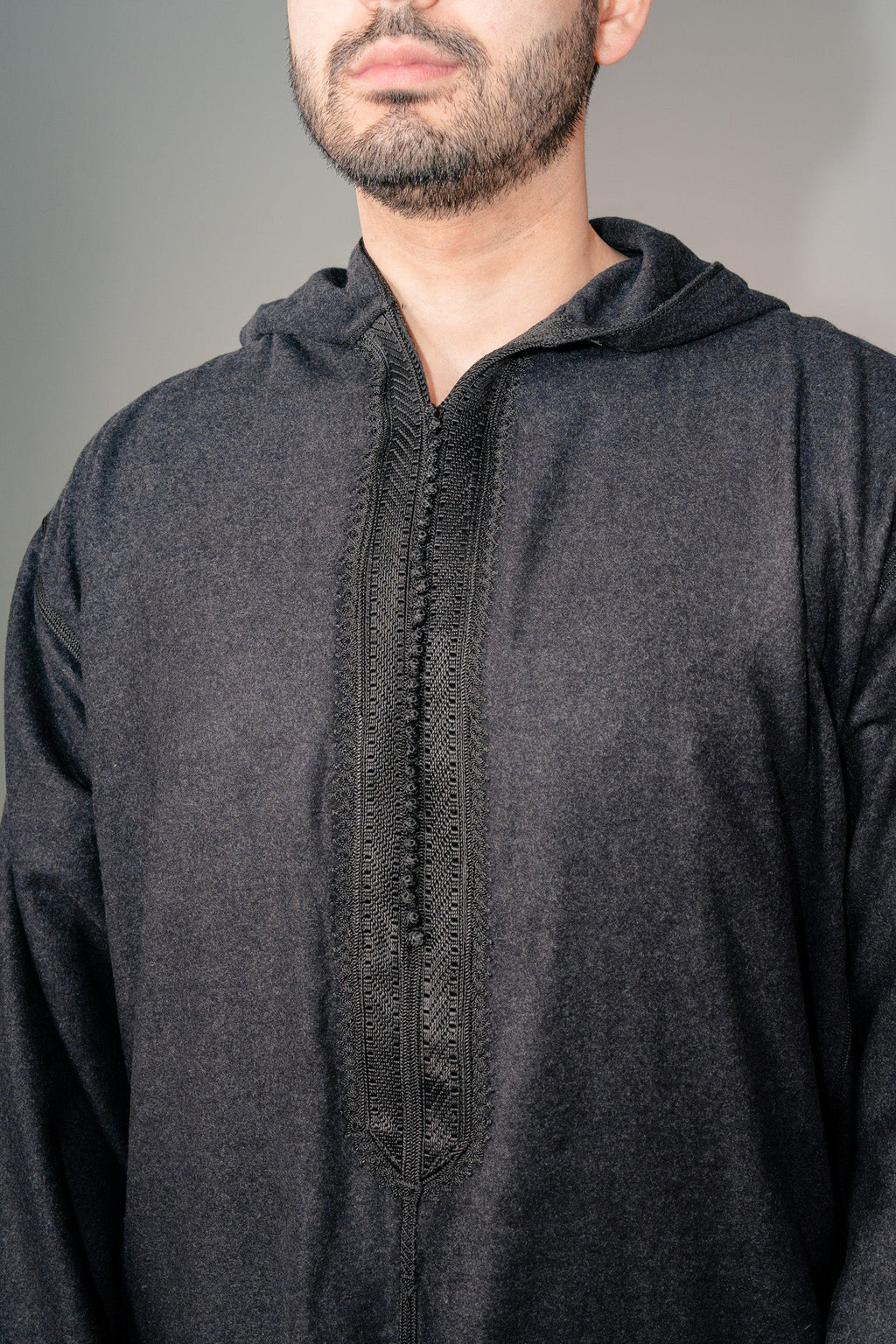 Embroidered placket and button loops on a black winter djellaba