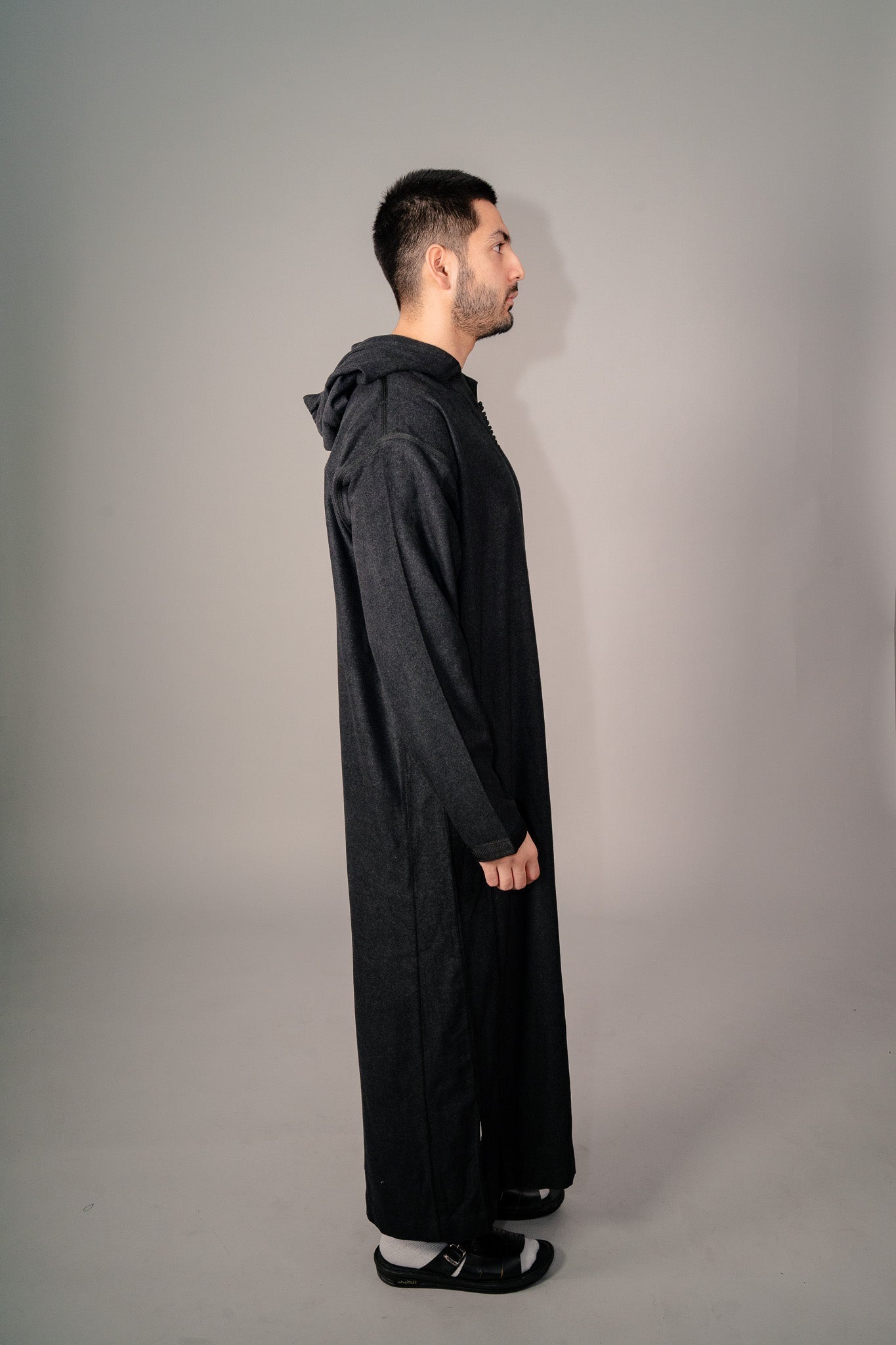 Side profile of a black Moroccan winter djellaba for men