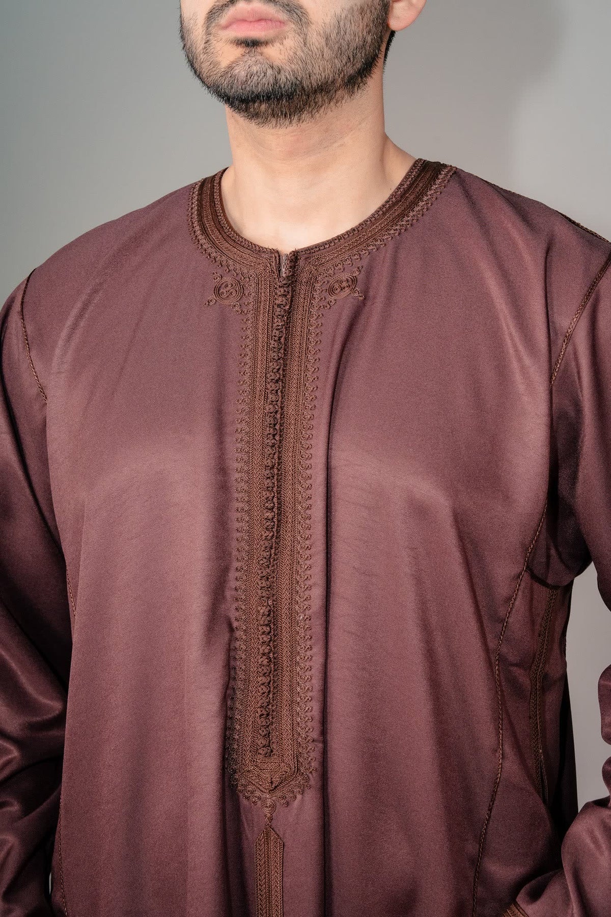 Embroidered placket and zip neck on a brown Moroccan kaftan