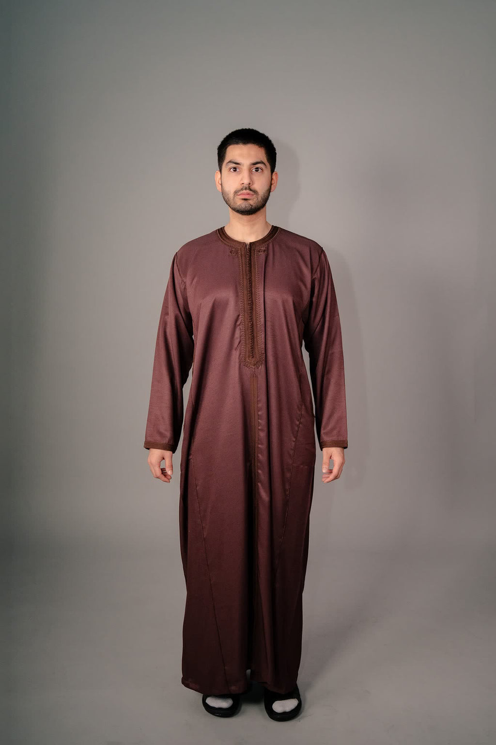 Man wearing a brown Moroccan kaftan for men, full length front view