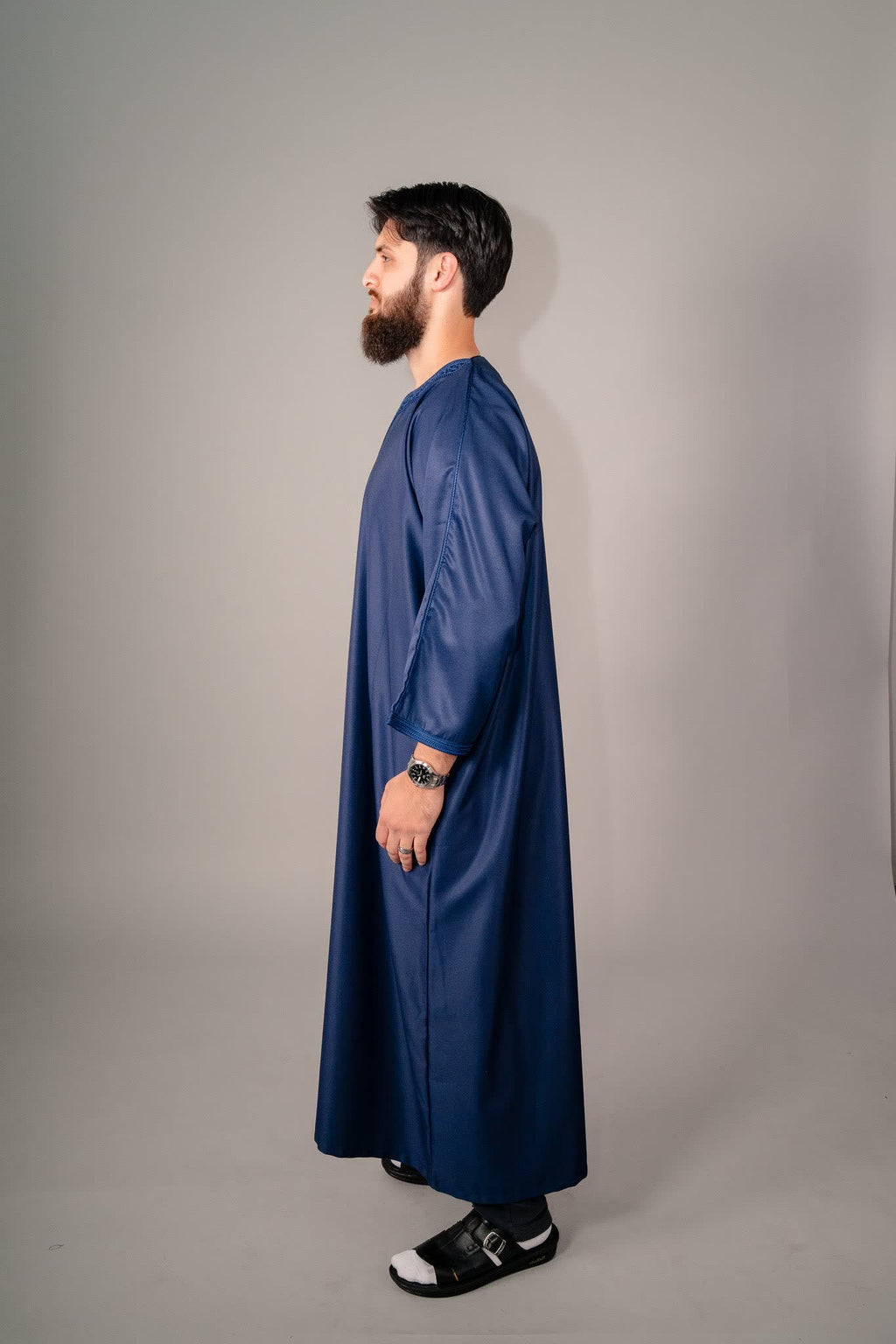 Fabric and stitching detail on a deep blue Moroccan gandoura