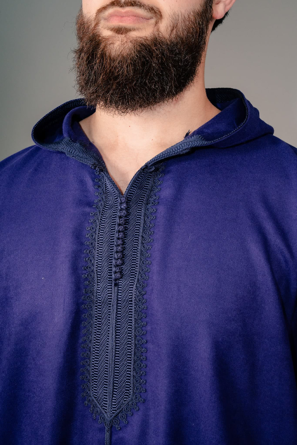 Embroidered placket and button loops on an indigo purple winter djellaba
