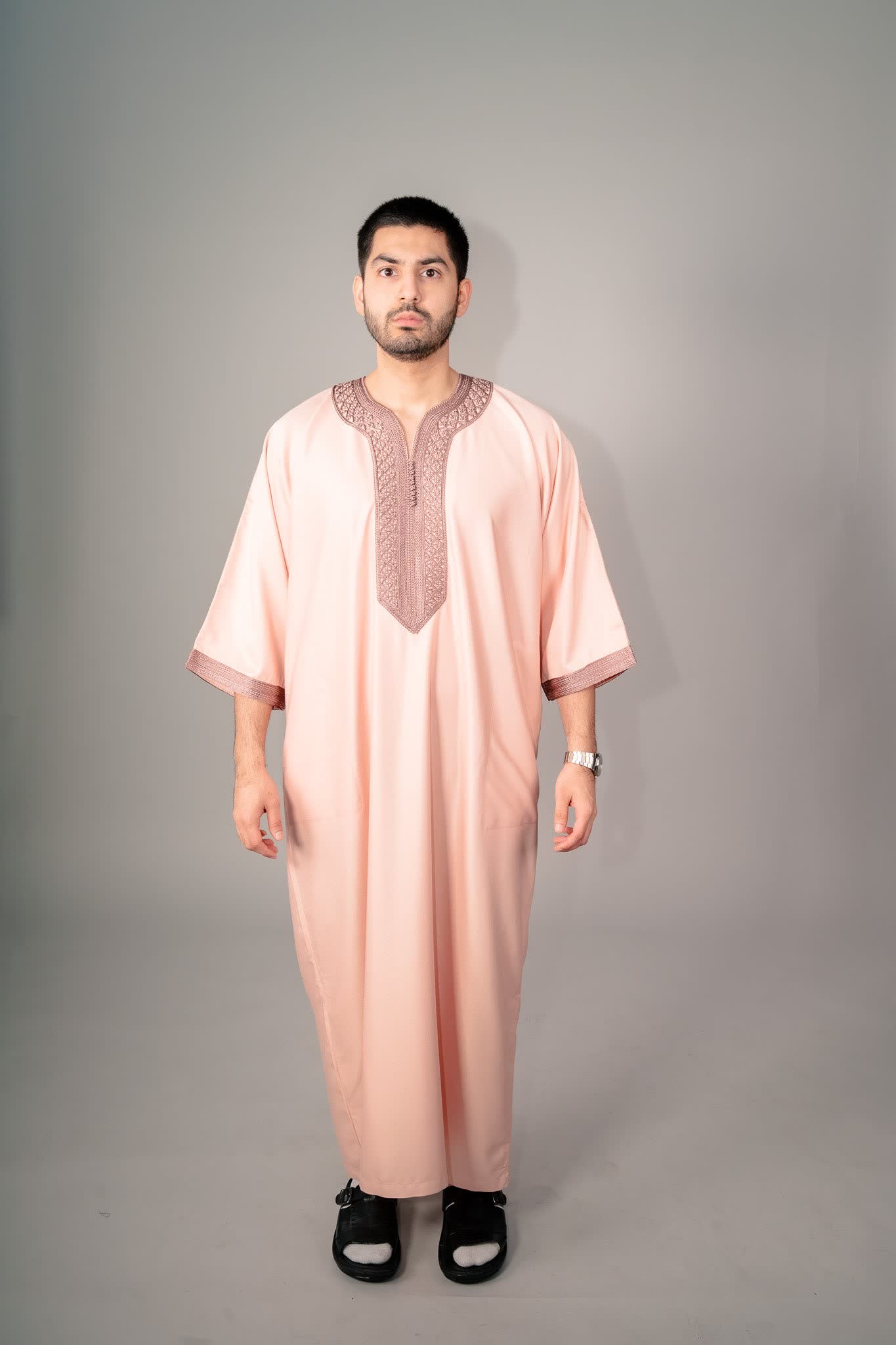 Man wearing a salmon Moroccan gandoura for a warm weather Eid