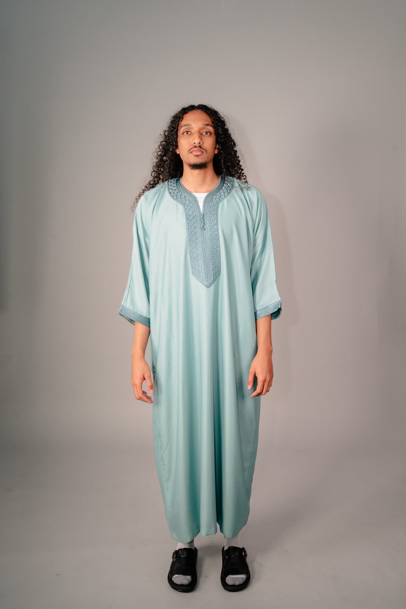 Man wearing a teal Moroccan gandoura, traditional summer clothing for men